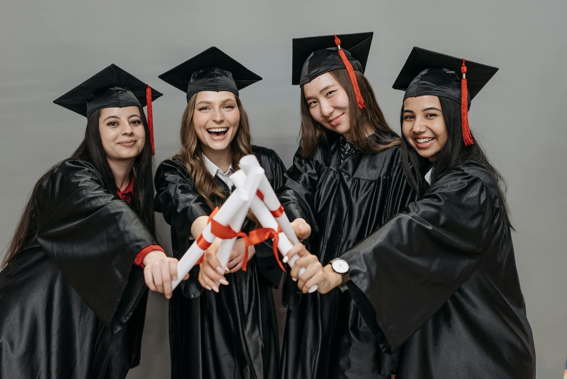 College graduates holding diplomas, representing past Marc Zboch Scholarships finalists
